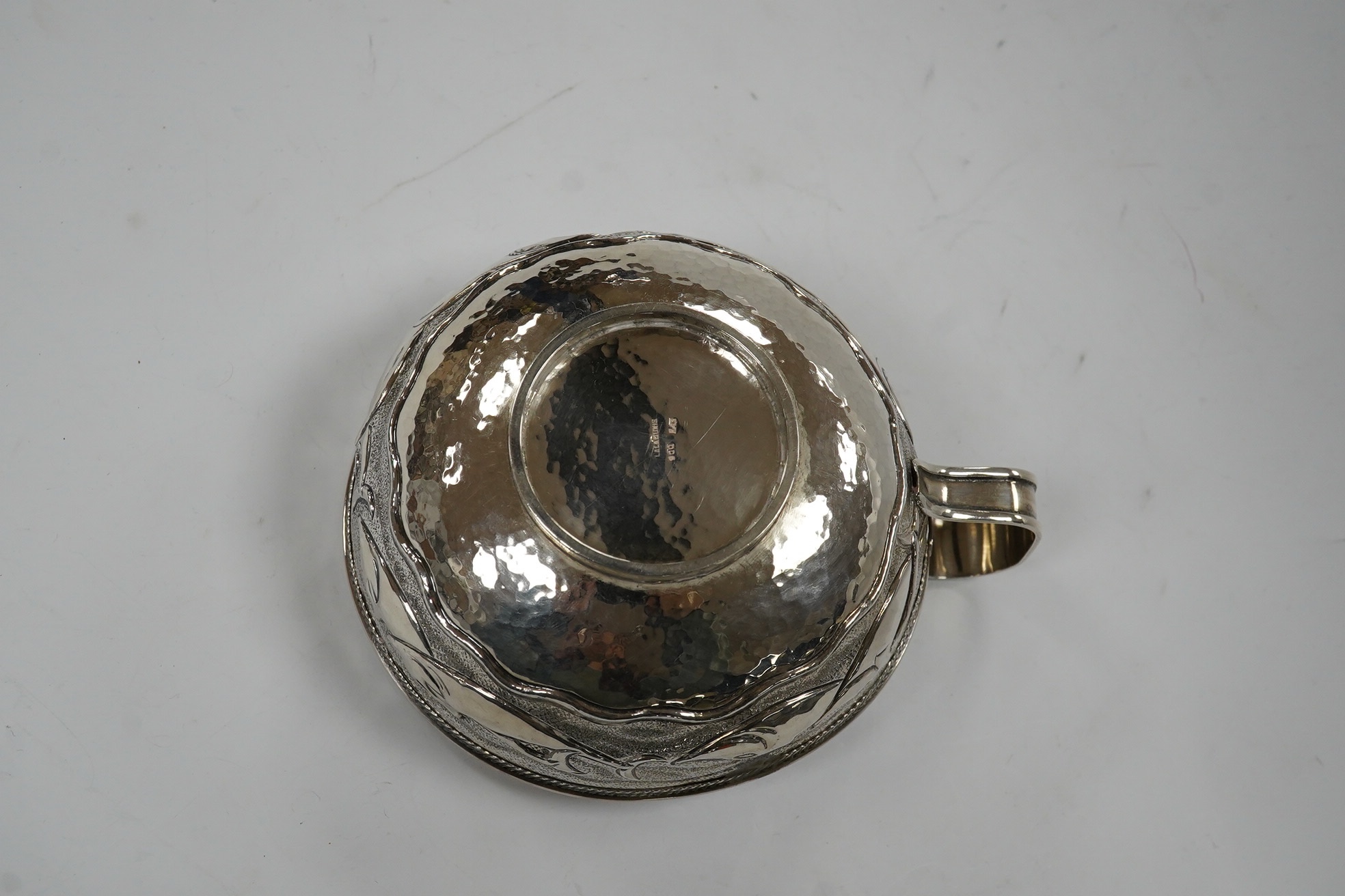 A Greek Lalaounis 800 standard white metal single handled cup, embossed with fish, diameter 11.5cm, 135 grams. Condition - fair